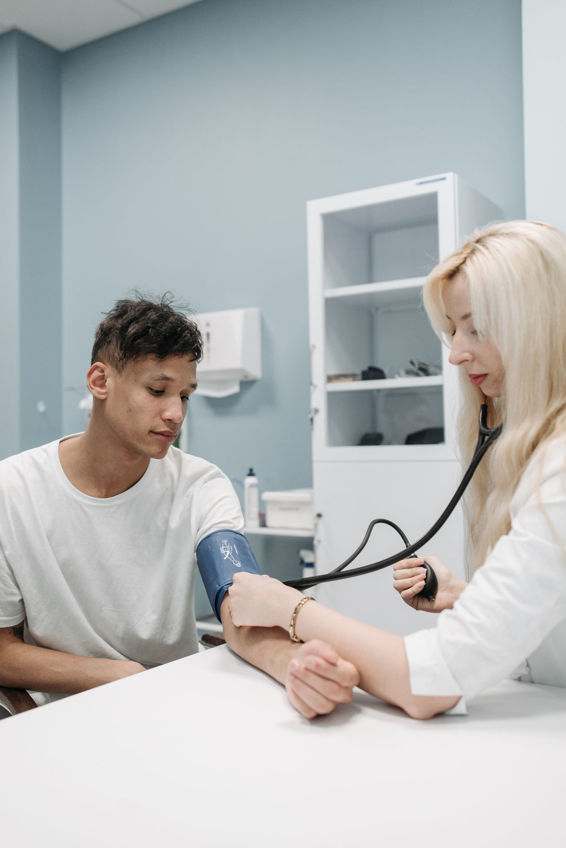 Doctor checking a man's blood pressure during a medical consultation